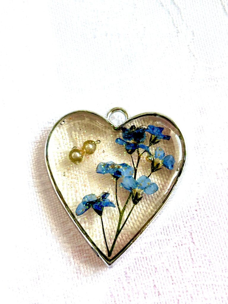 beginner guide to crafting with uv resin a bezel with added flowers and pearls