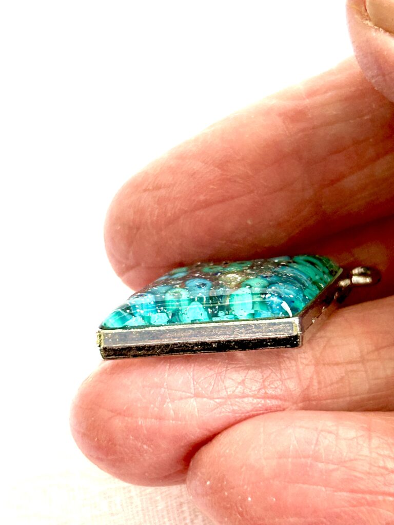 close up shot of a pendant showing the dome of resin