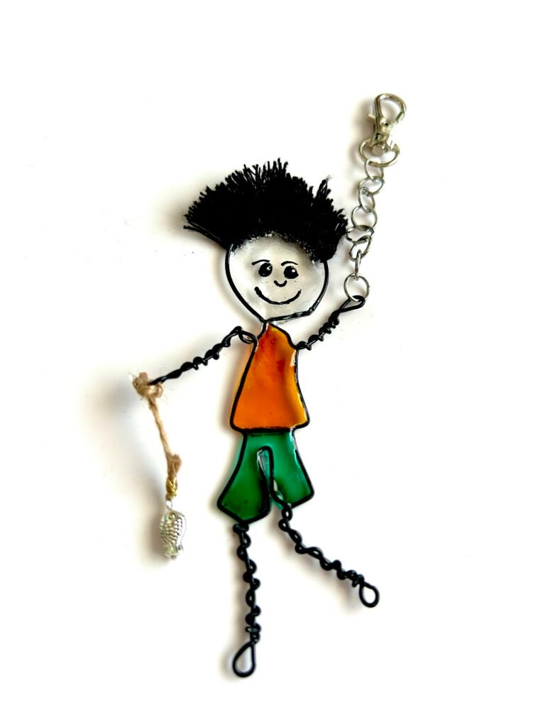 mary-anne character bag charm keyring a boy who loves fishing carrying a silver fish on a string short cropped spiky black hair handpainted face made with wire and resin 