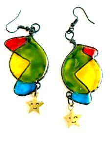 How to photograph your creations for market. Pair of abstract style earrings brightly coloured with a smiley winking charm attached 