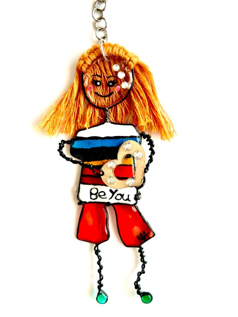 Pride characters from the Mary-Anne Collection Be You character bag charm -sparkles on face rainbow t shirt carrying a heart