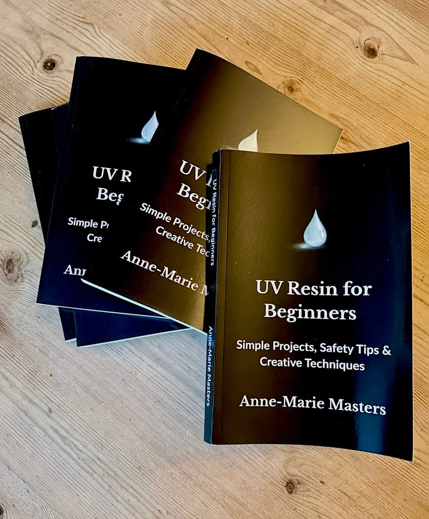 pile of books with black cover and white text that reads UV Resin for Beginners